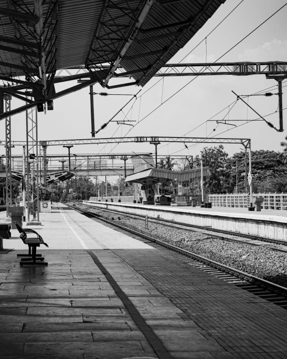 a person sitting on a bench at the train station