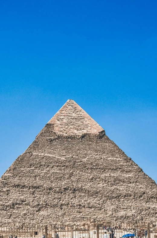 a tall sphinx structure with a large sky in the background