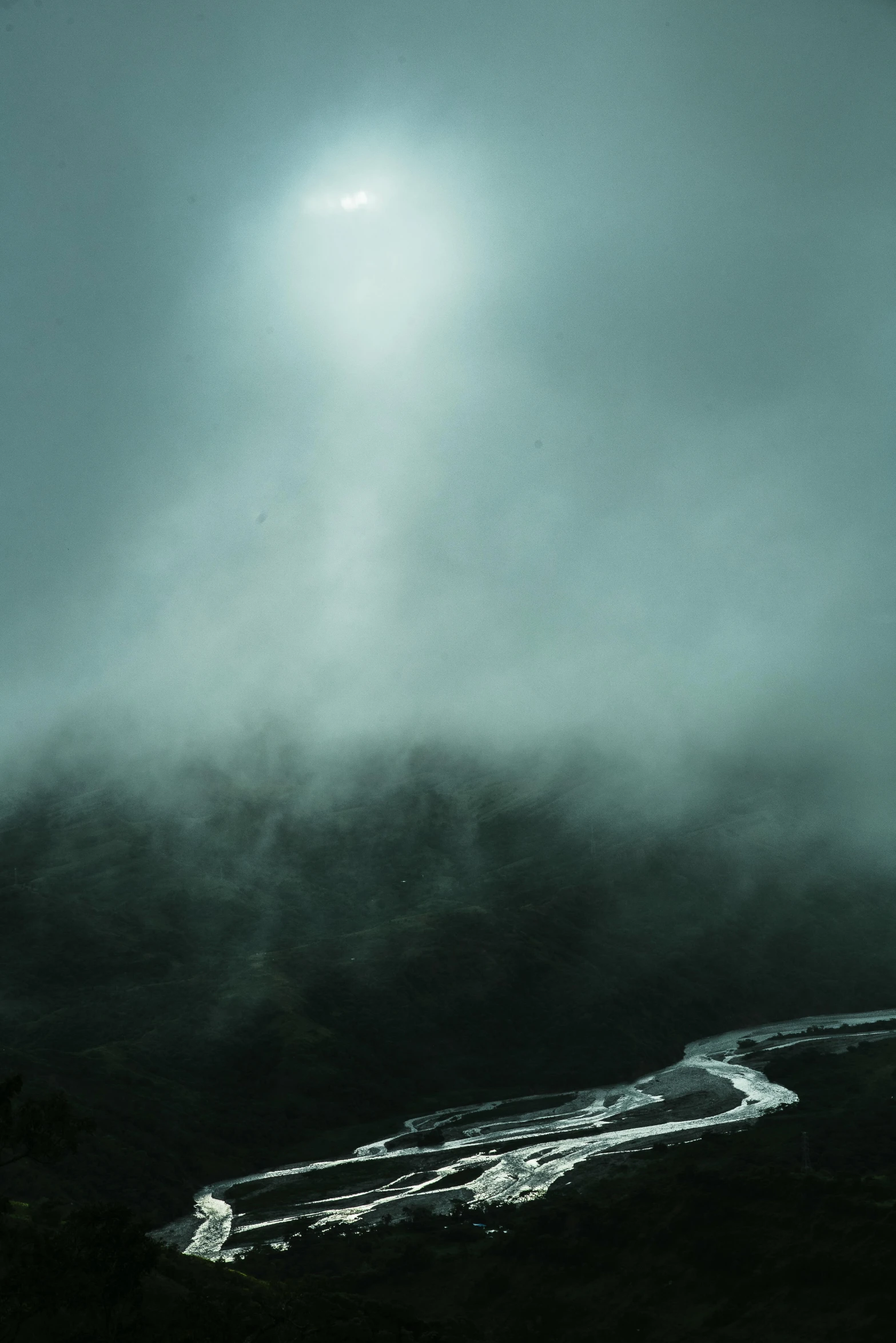 the view from the top of a hill with water in the foreground