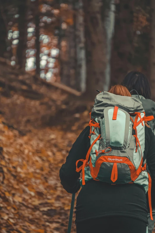 there is a person wearing a backpack with an orange bow