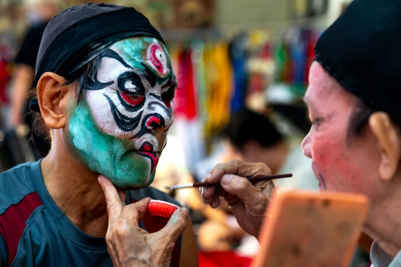 a person in a face paint painting contest