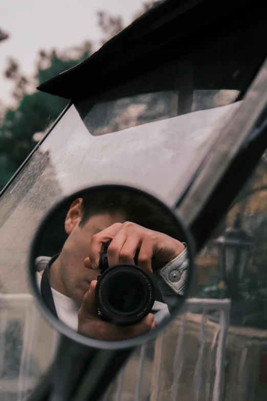 a man holding up his camera to take a po