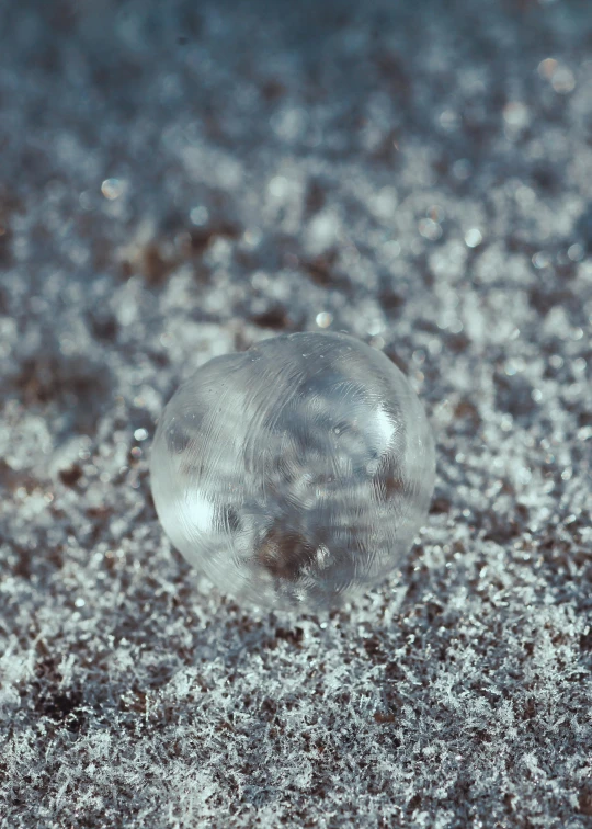 a clear object sits on a dirty surface