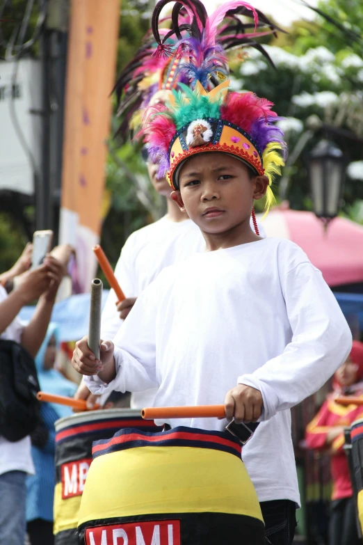 a boy in a costume that is holding a bag