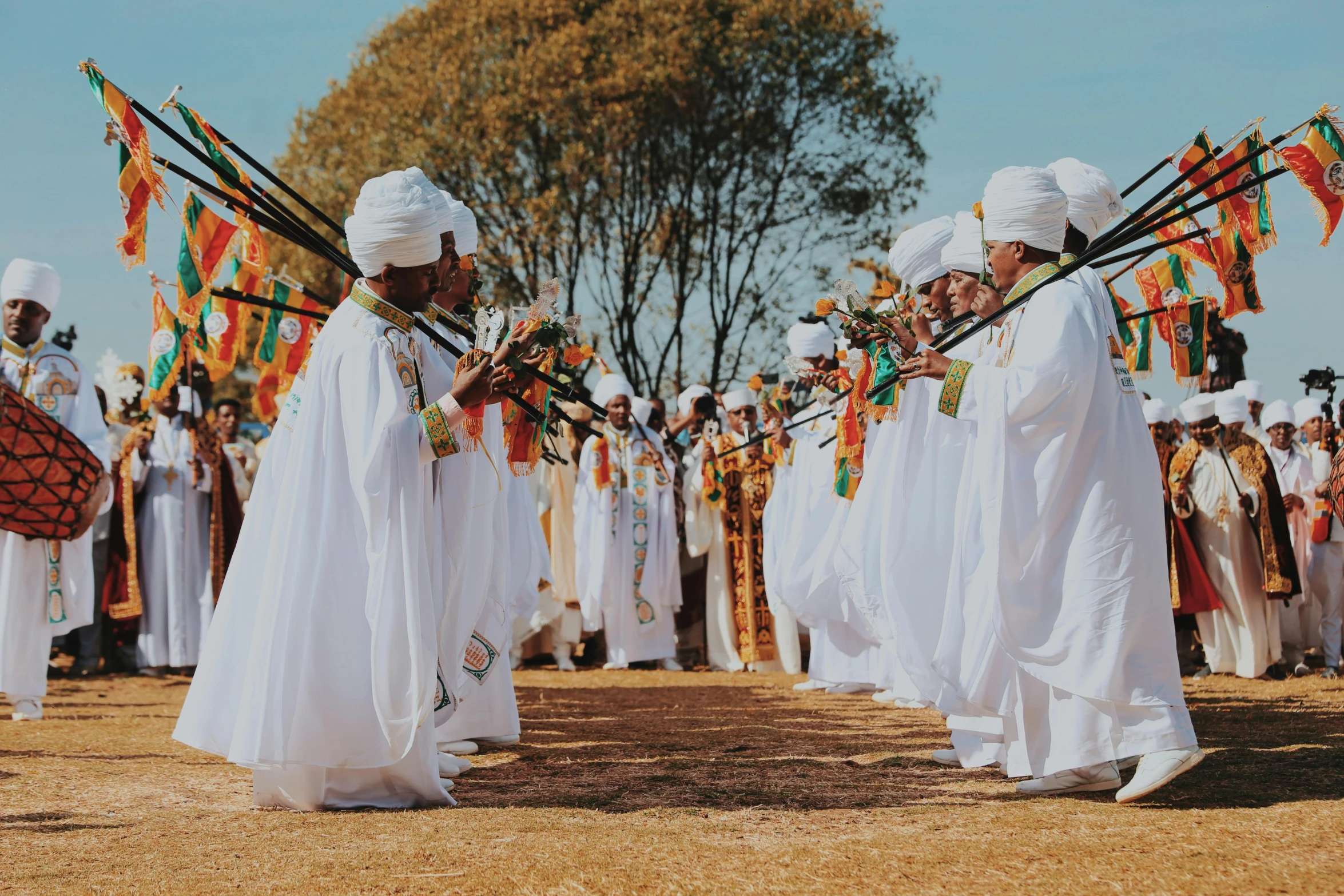 a group of s holding sticks standing on a field