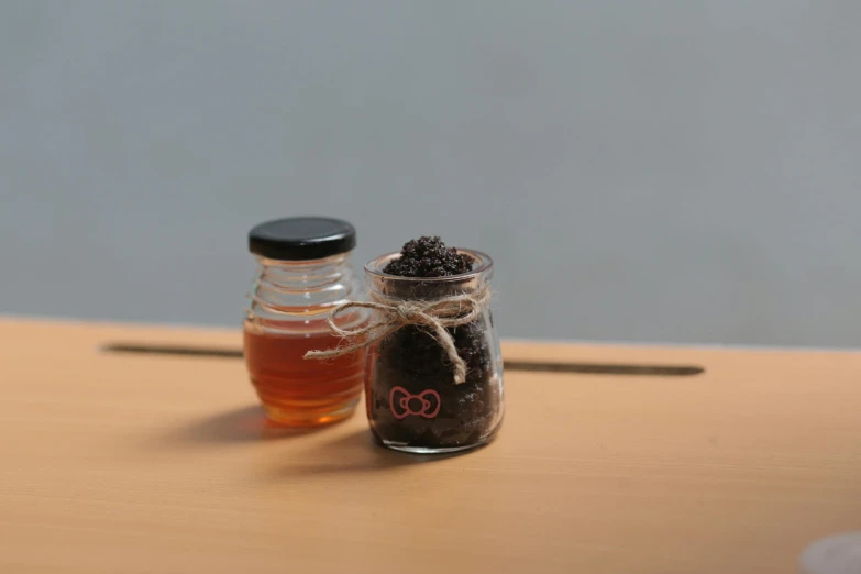 a jar full of tea next to another jar