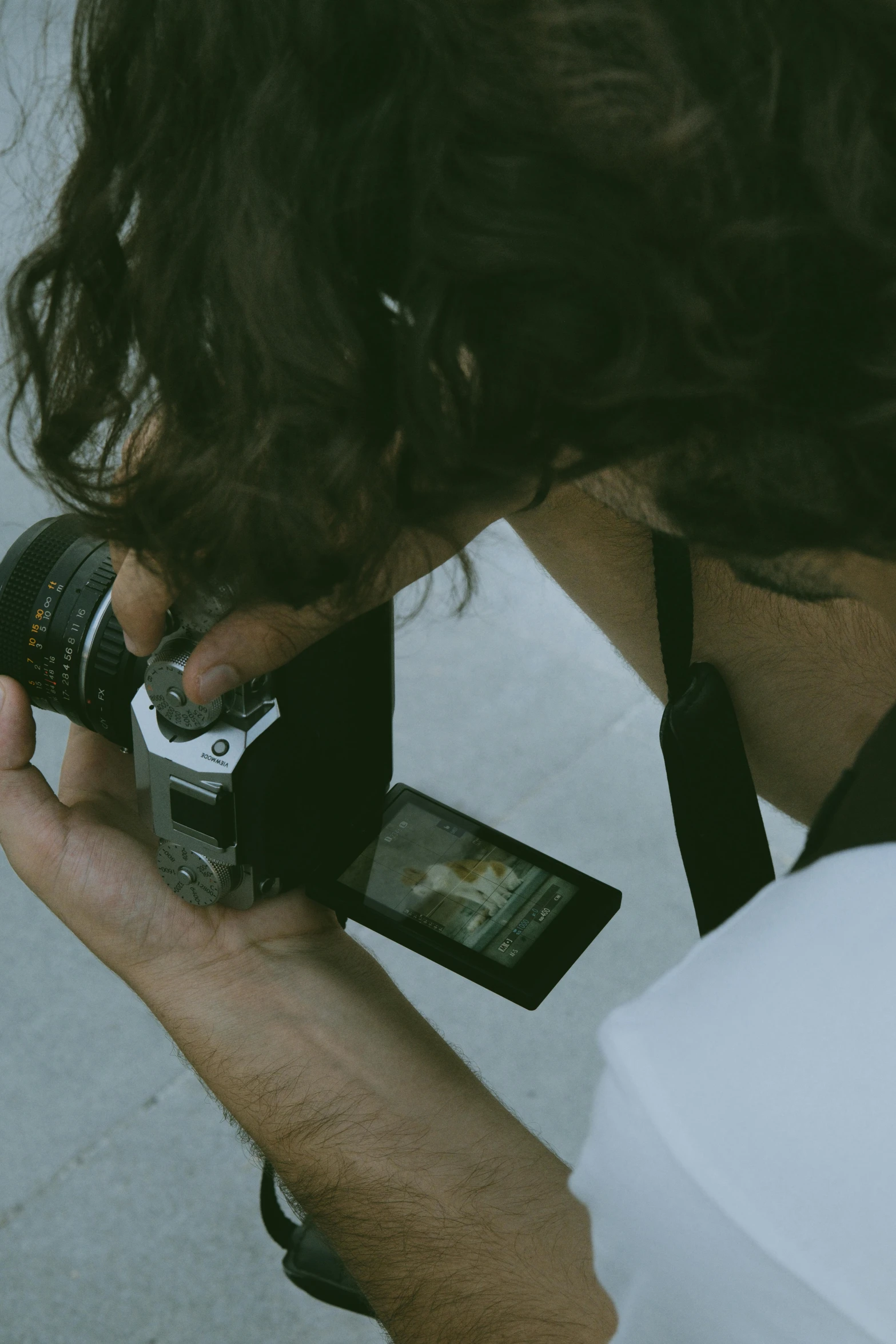 person holding camera with a long hair taking picture