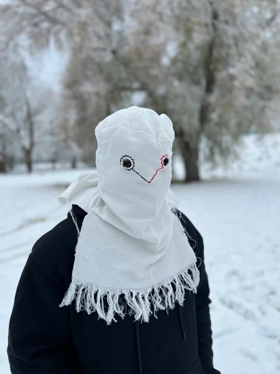 an ugly white hooded bear wearing a white scarf