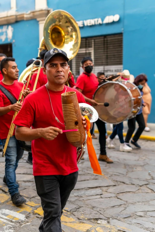 several men dressed in red playing musical instruments