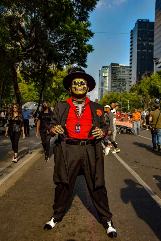 a skeleton is wearing a red shirt, black pants and a hat