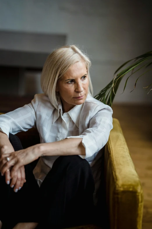 a woman is sitting on a couch in the room