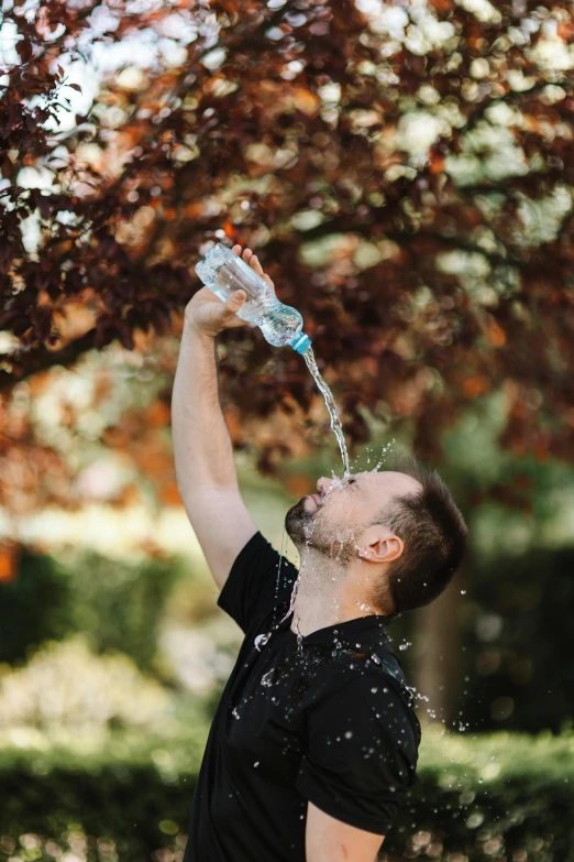 a man reaching up to grab a water bottle