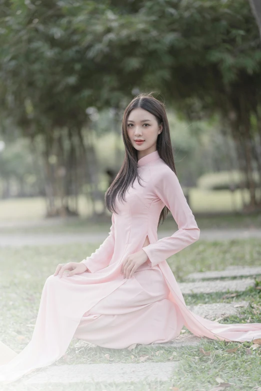 asian woman in dress sitting down and posing for po