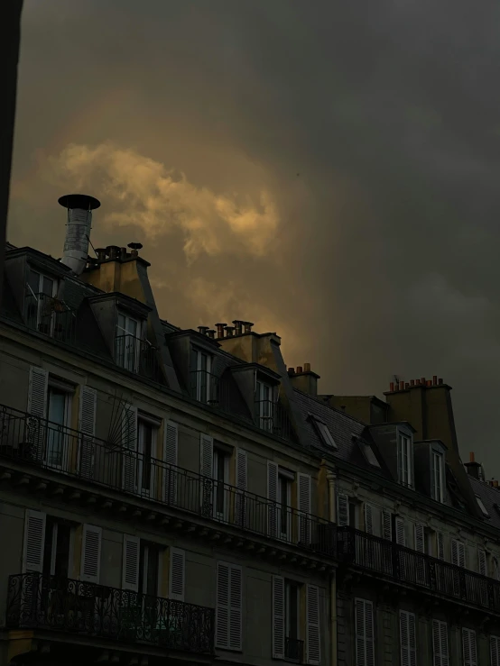 the dark sky is gathering over some building