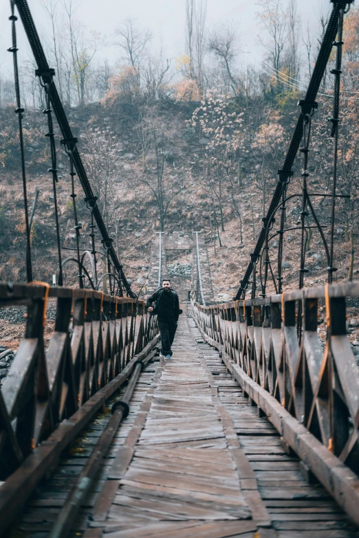 a bridge that is over looking a mountain and trees