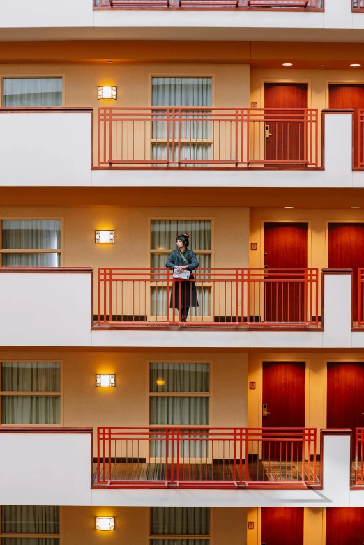 a person standing on the balconies of an apartment building