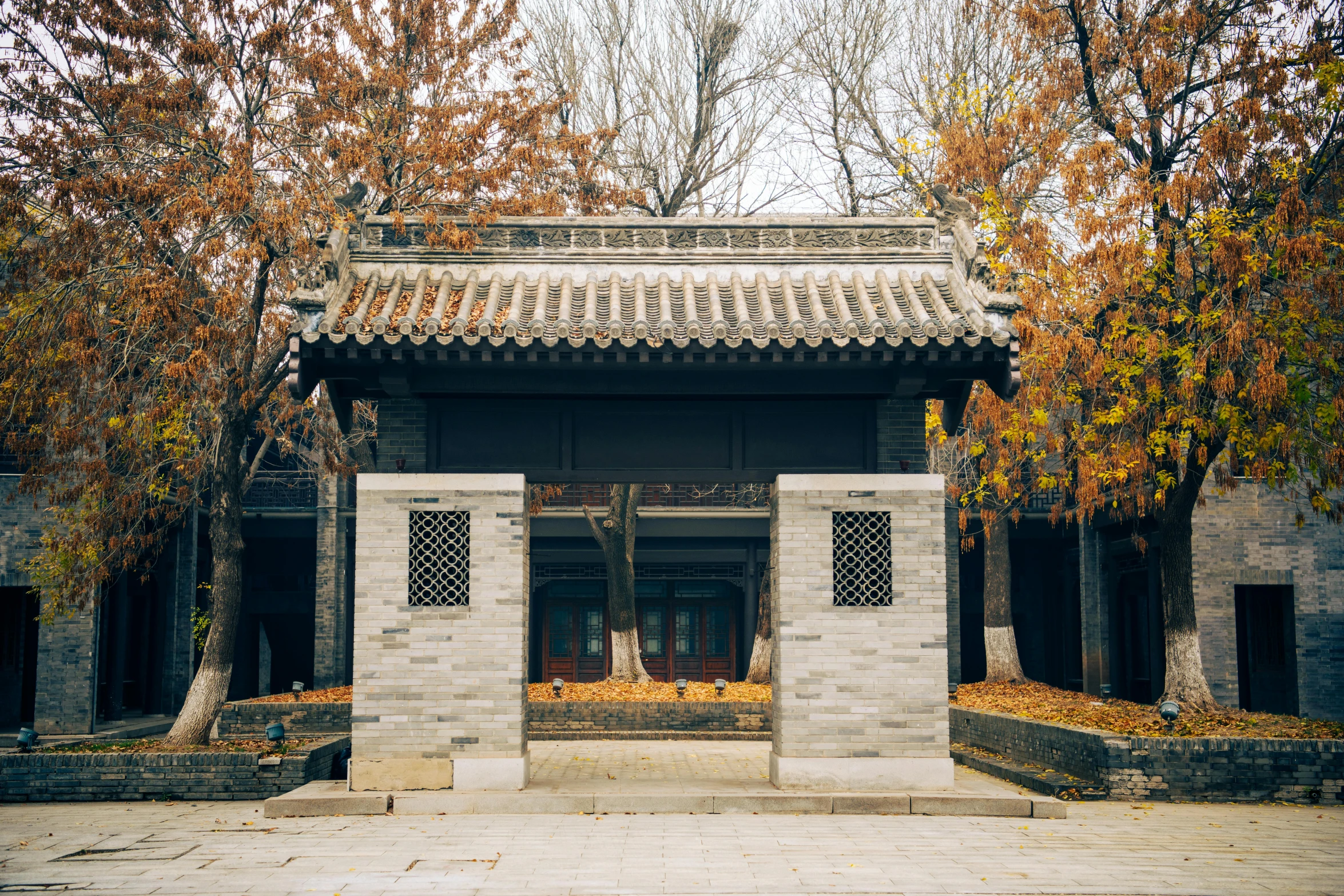 an old asian building in the woods on autumn day