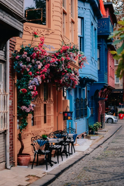 an open air cafe with colorful buildings and flower pots