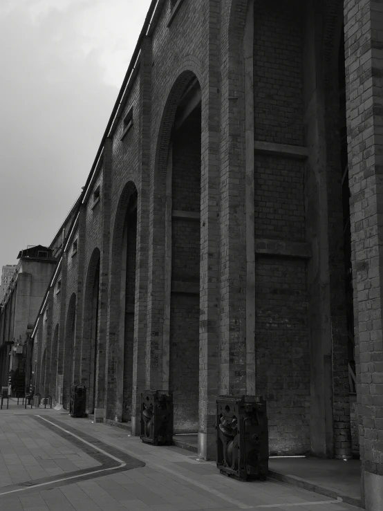 an old brick structure stands beside a street