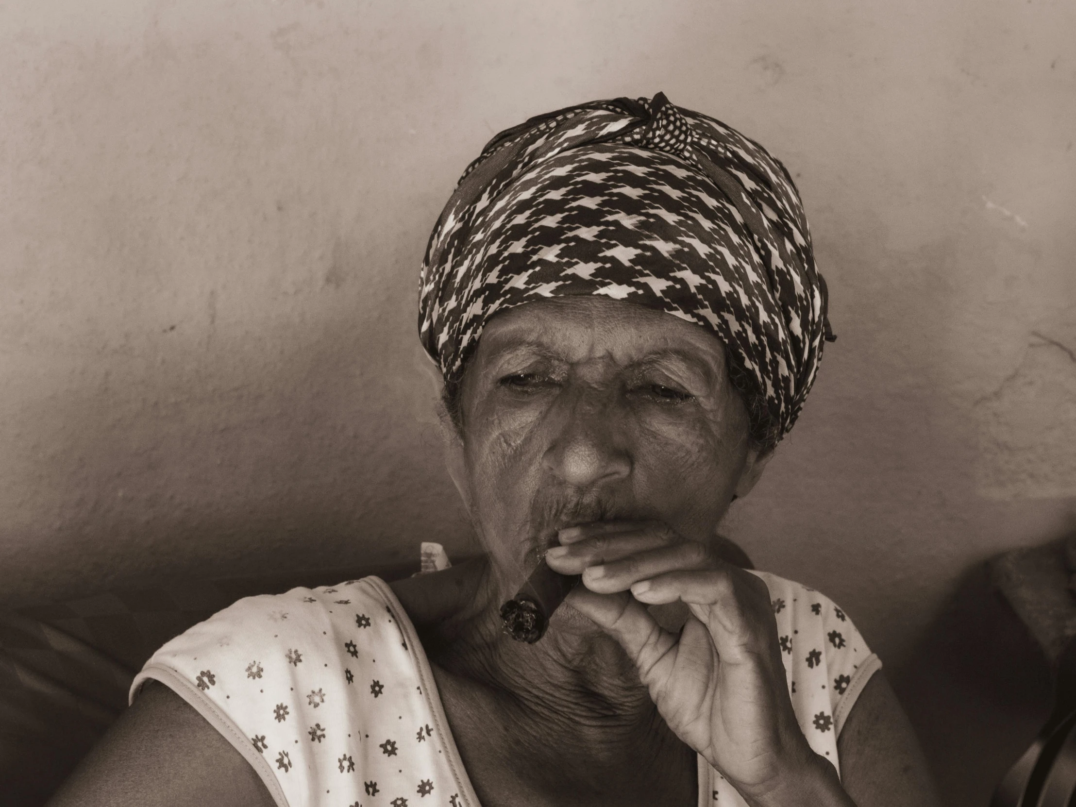 an older woman smoking cigarette in her home