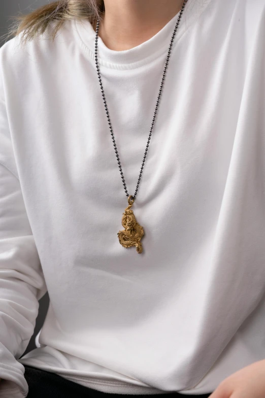 a woman wearing a white shirt and black necklace