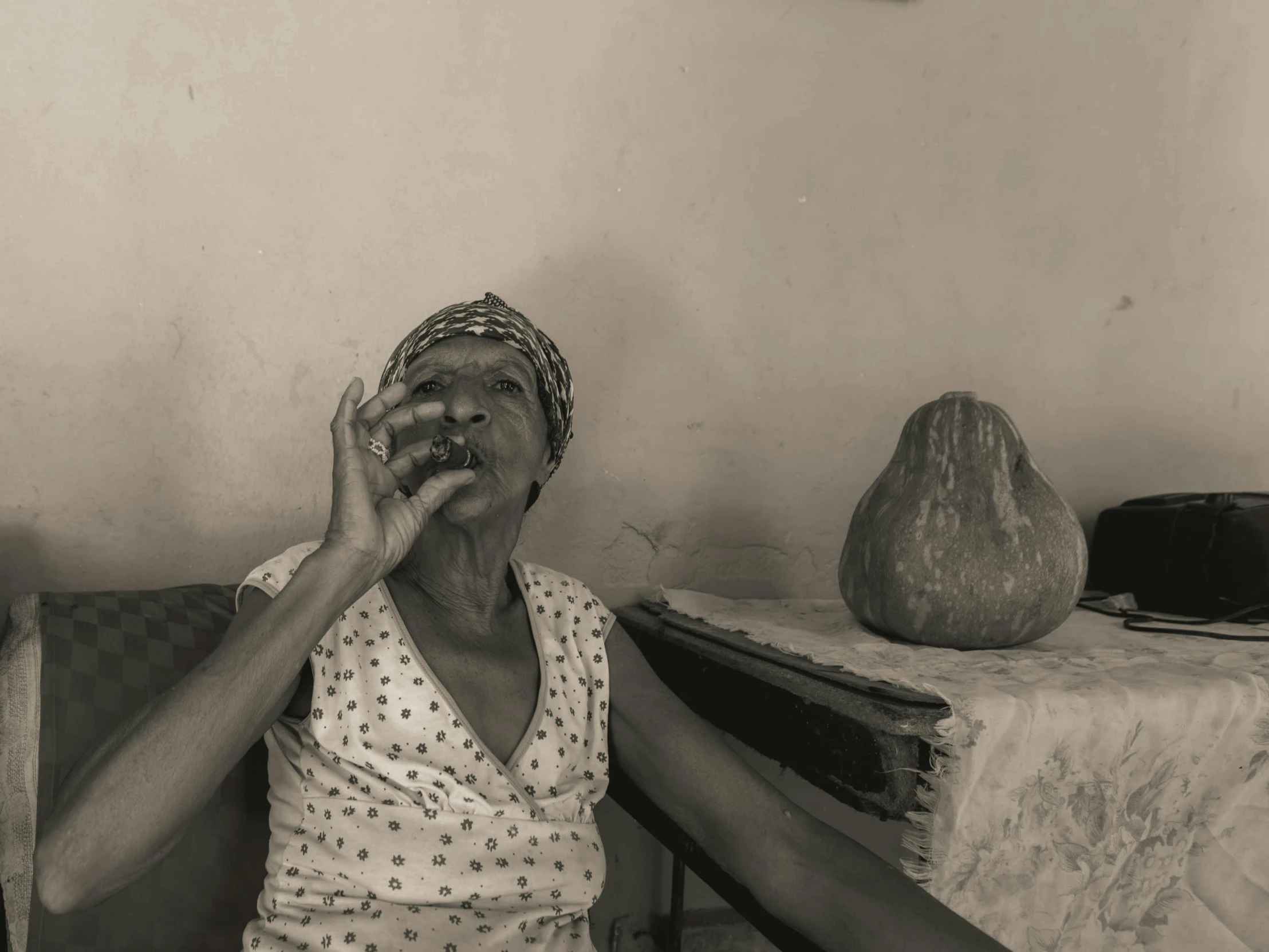 an elderly woman sitting on a chair with soing in front of her