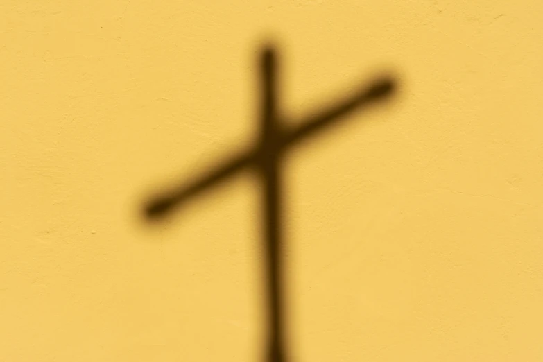 a closeup of a cross made out of wire on the wall