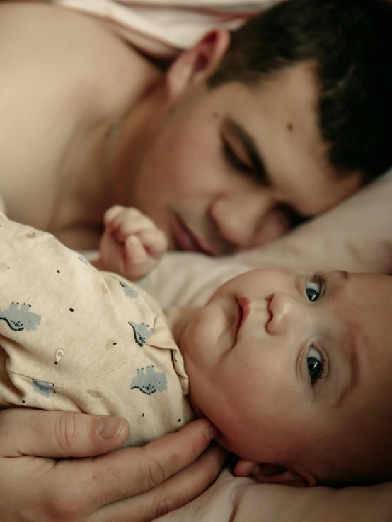 a man holding his baby up to him