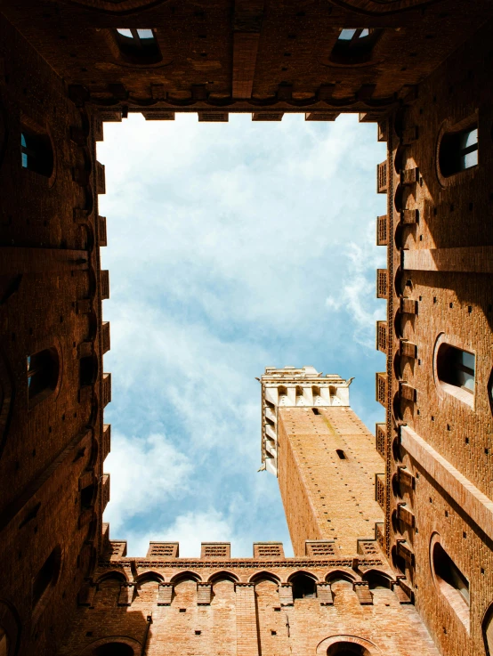 a very old looking tower block with the sky seen through it