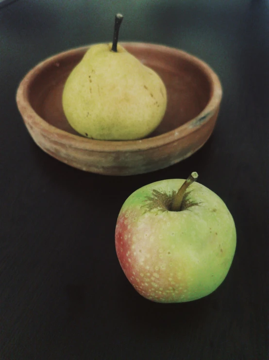 two pears are sitting in front of one another