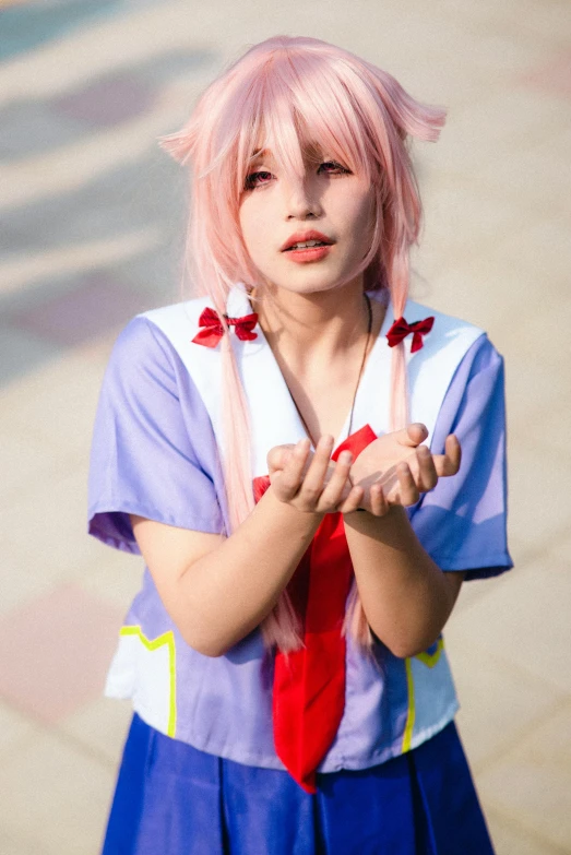 a woman with pink hair in a blue dress and red tie