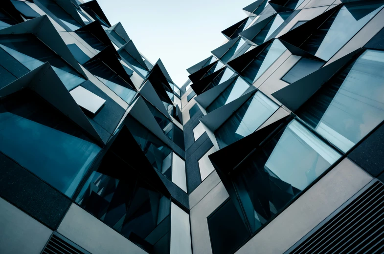 an abstract view of a tall building with a sky background