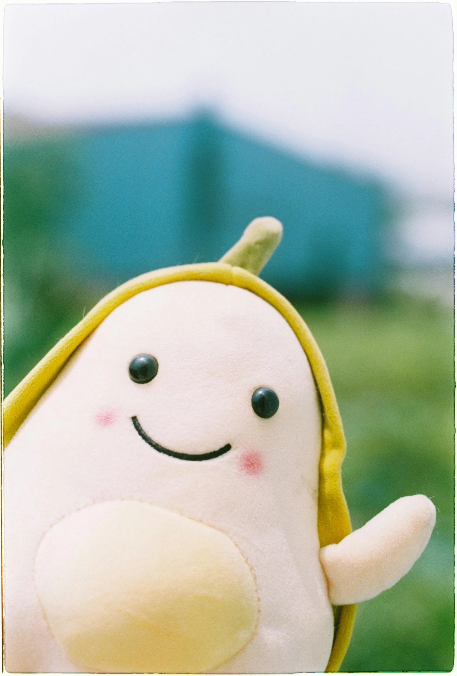 a stuffed toy in the shape of a smiling character