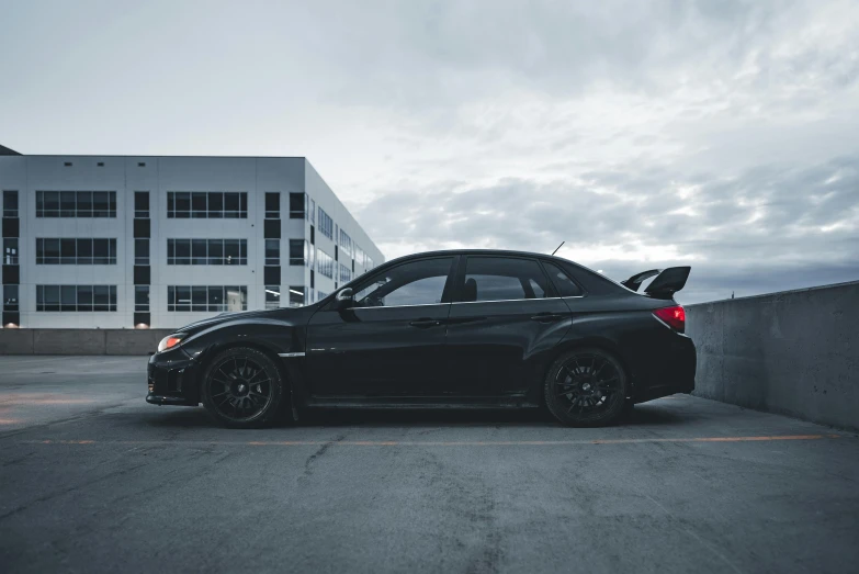 a car parked in a parking lot next to some large buildings