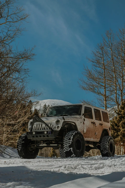 a muddy truck drives through the snow