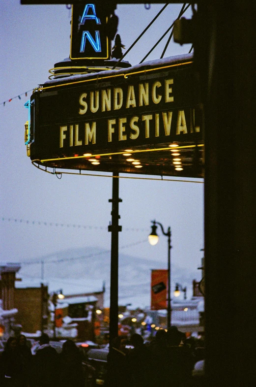 a movie sign hanging from the side of a building