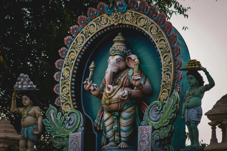 a statue of a man with an instrument stands in front of other statues