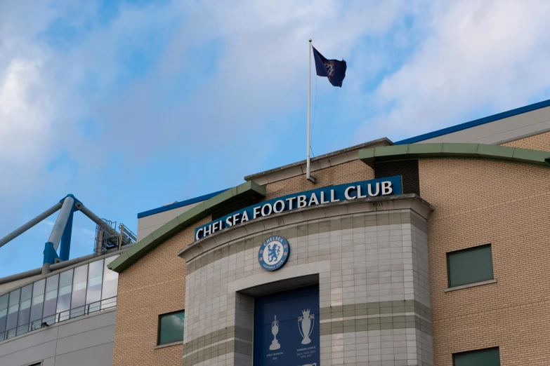 the flags and blue flag are flying outside the football club