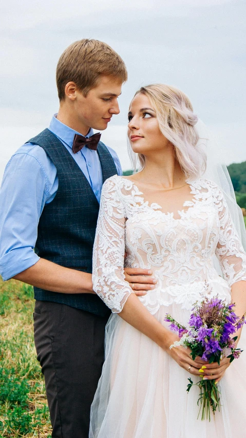 young couple dressed in brides clothing standing side by side