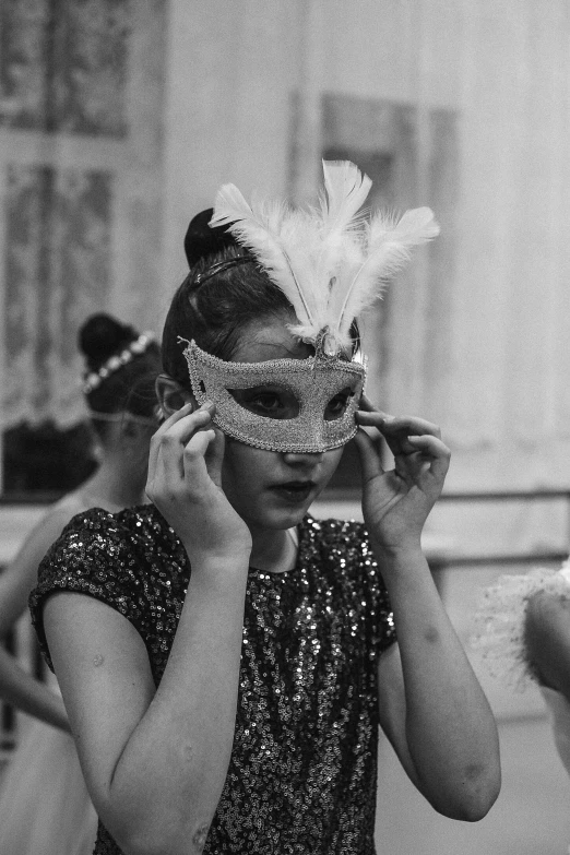 a young woman wearing a mask in the middle of a dance