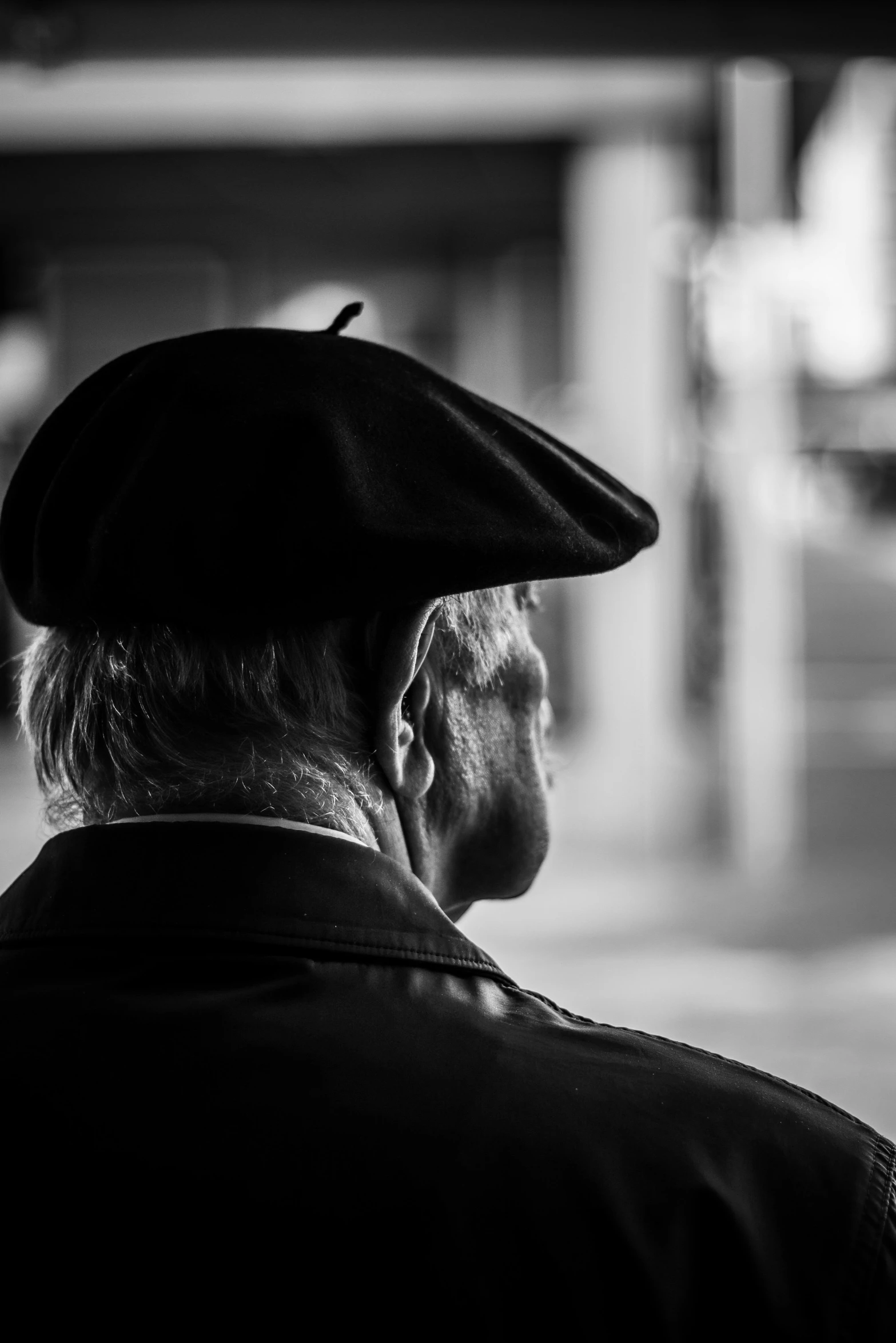 a black and white po of an older man with a hat