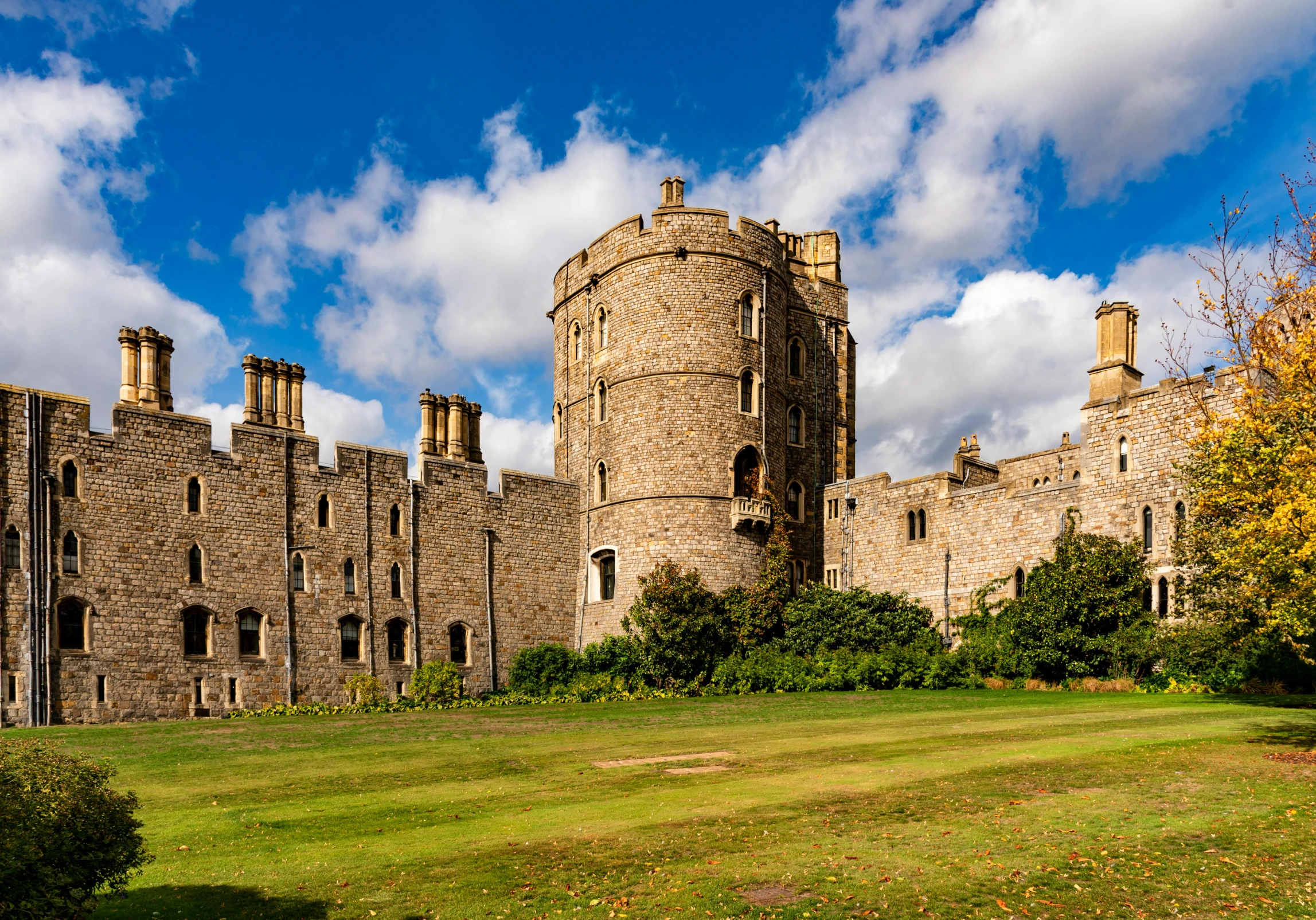 the sky over a stone castle and grassy field