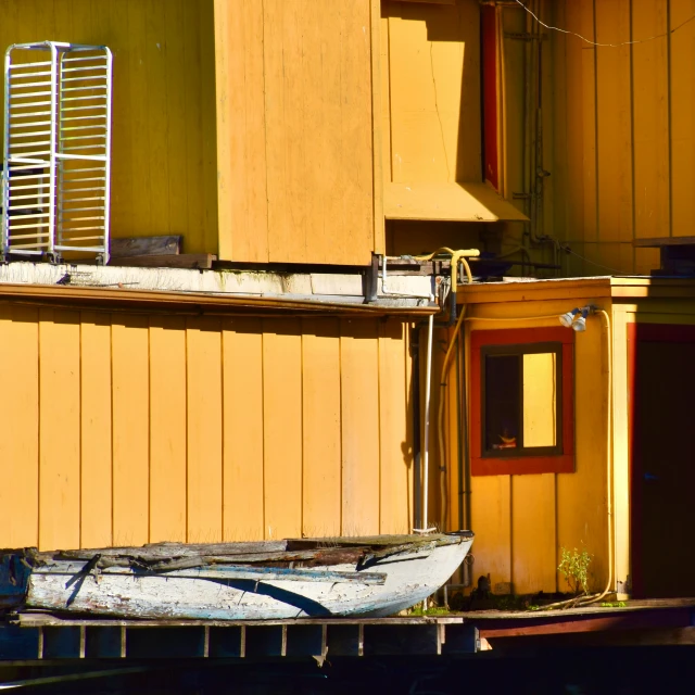 boat sitting on the water in front of some brown buildings