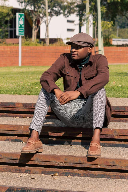 a man in a hat is sitting on a wooden bench