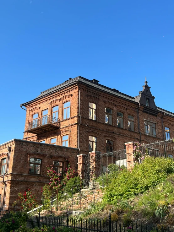 a building with many windows near bushes