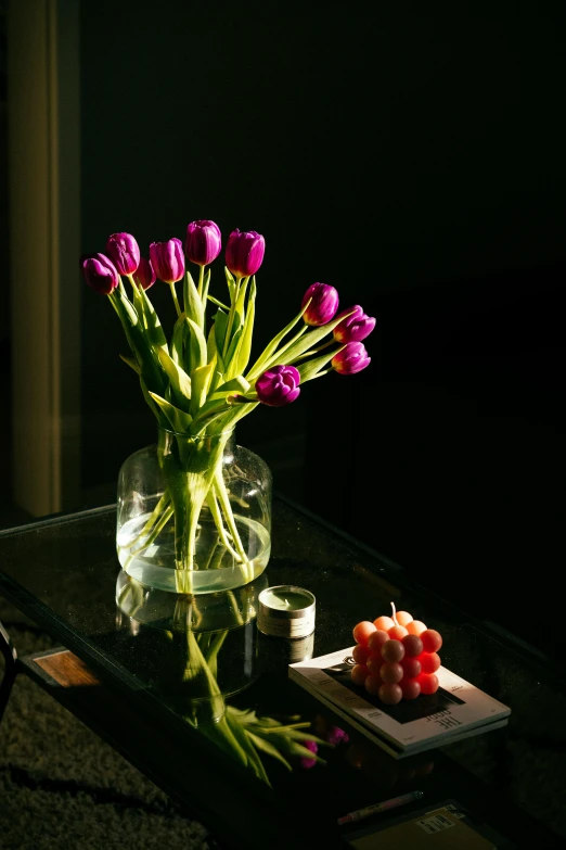 flowers and a  board sitting on a glass table