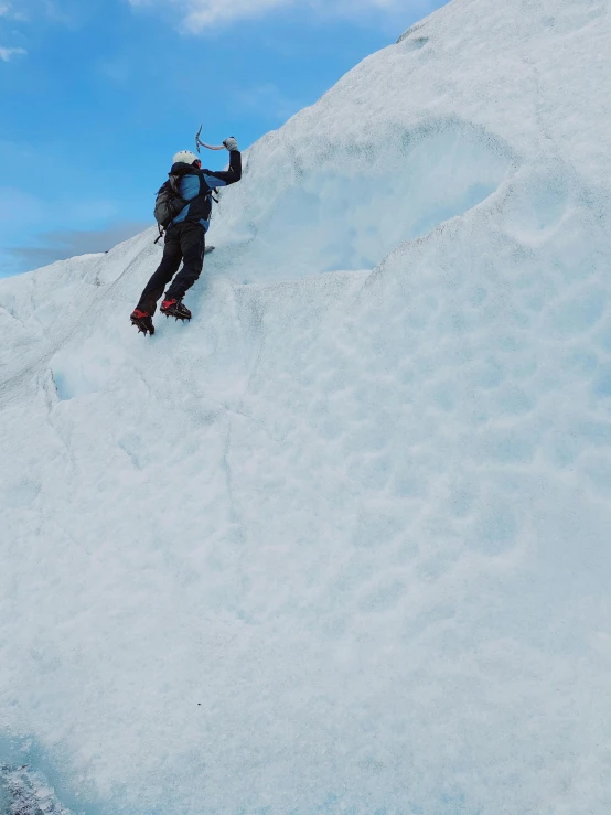 person in full gear up in the air while skiing on a slope