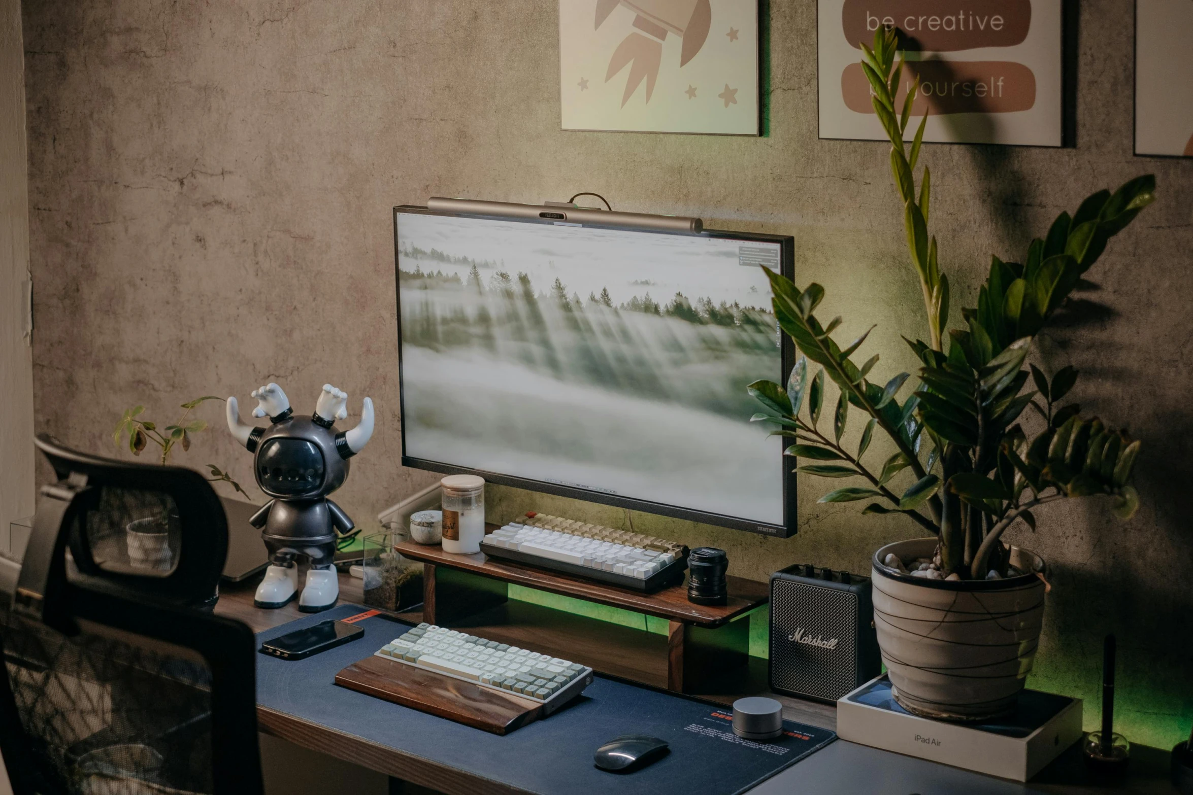 a tv screen hanging over a wooden desk