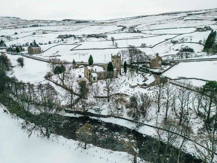 an aerial view of a small snowy village