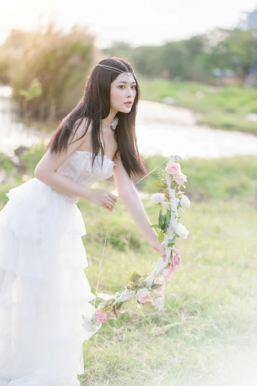 a girl in a dress is holding a floral bouquet